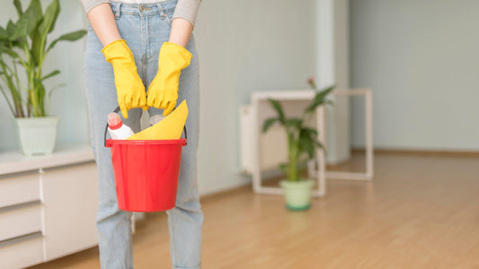 End of tenancy cleaning – cleaner holding bucket in clean apartment